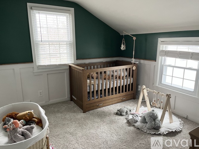 A baby's room with a crib and a play gym.