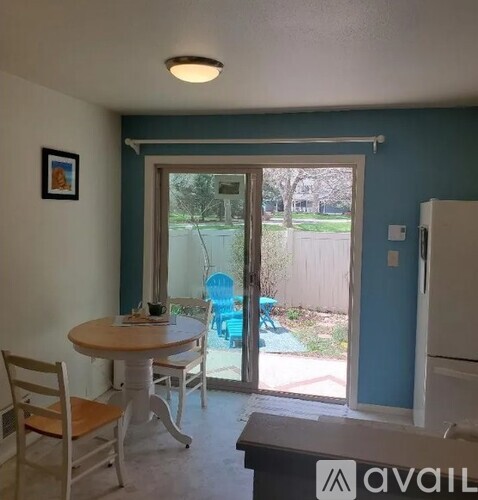 A dining area with a table and chairs is shown.