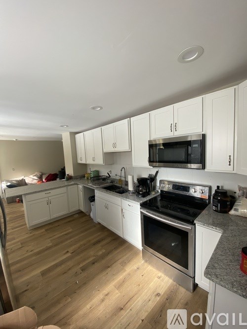 A kitchen with white cabinets and stainless steel appliances.