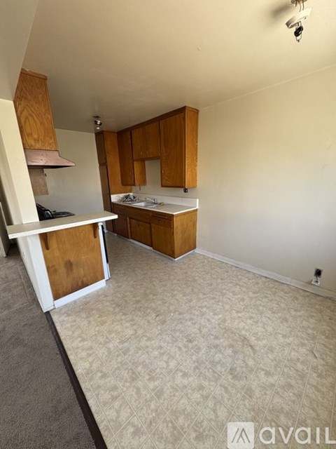 A kitchen with wooden cabinets and a white countertop.