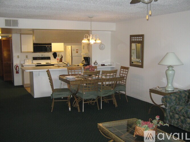 A dining room with a glass table and chairs.