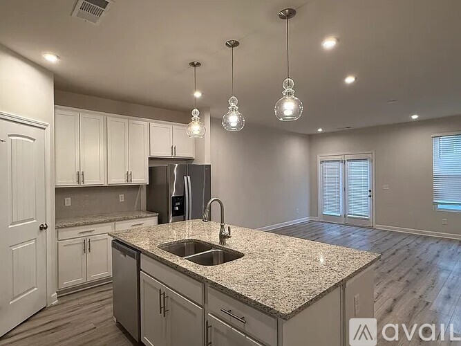 A kitchen with granite countertops and a sink.