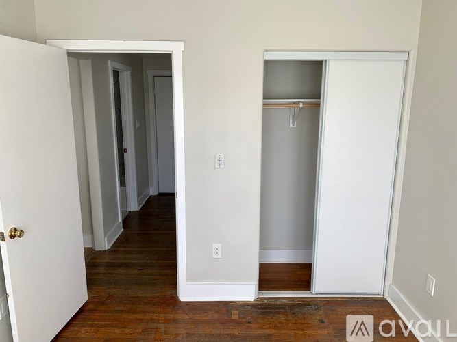 A white door is open to a hallway.