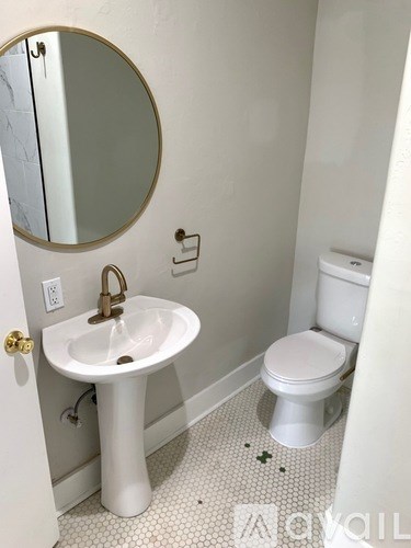 A white sink and toilet in a small bathroom.