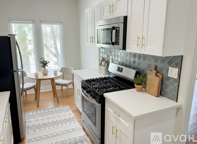 A kitchen with a black stove top oven and a microwave above it.