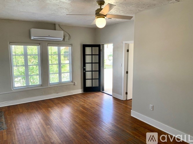 A room with wood floors and a ceiling fan.