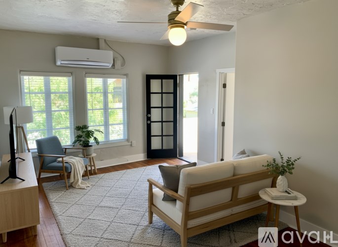 A room with a window and a wooden floor.