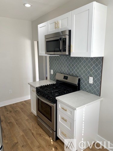 A kitchen with a stove top oven and microwave above it.
