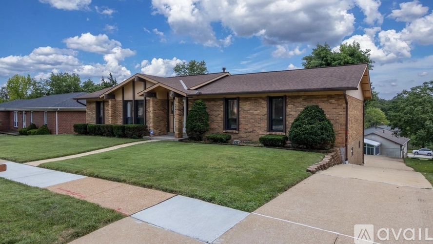 A house with a brown roof and a white fence is available for sale.
