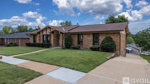 A house with a brown roof and a white fence is available for sale.