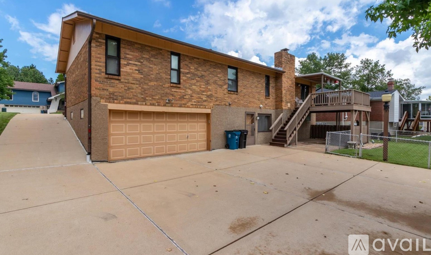 A two-story house with a garage and a driveway.