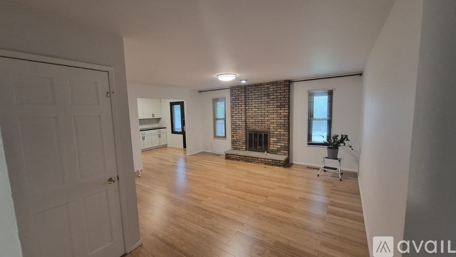 A room with a fireplace and a chair.