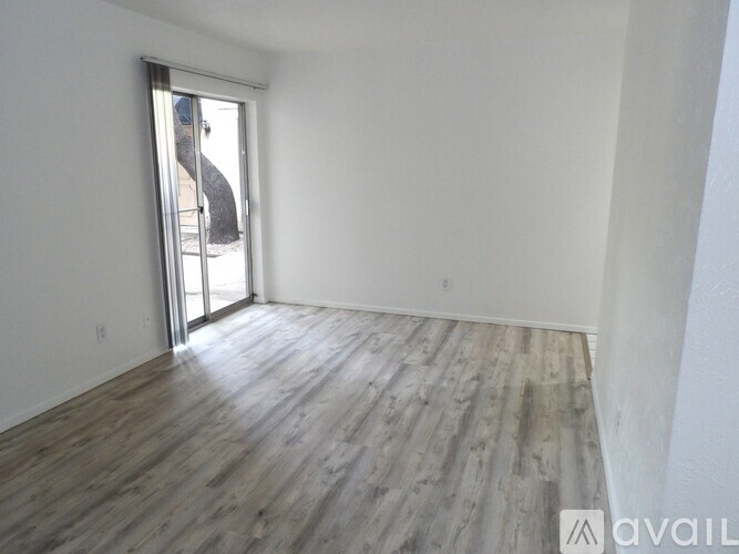 A long white hallway with a tiled floor.