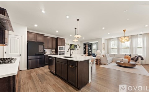 A modern kitchen with dark wood cabinets and a white island.