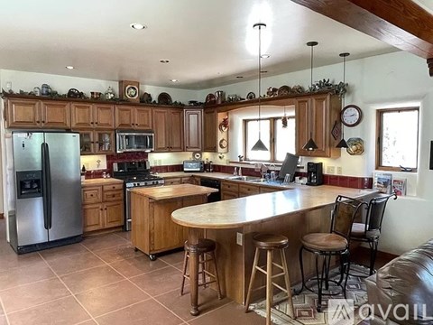 A kitchen with wooden cabinets and a large island.