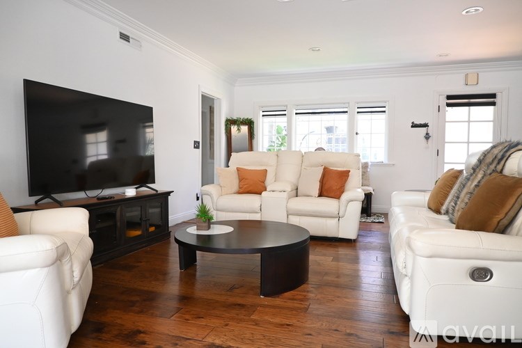 A fireplace with candles and greenery on top.