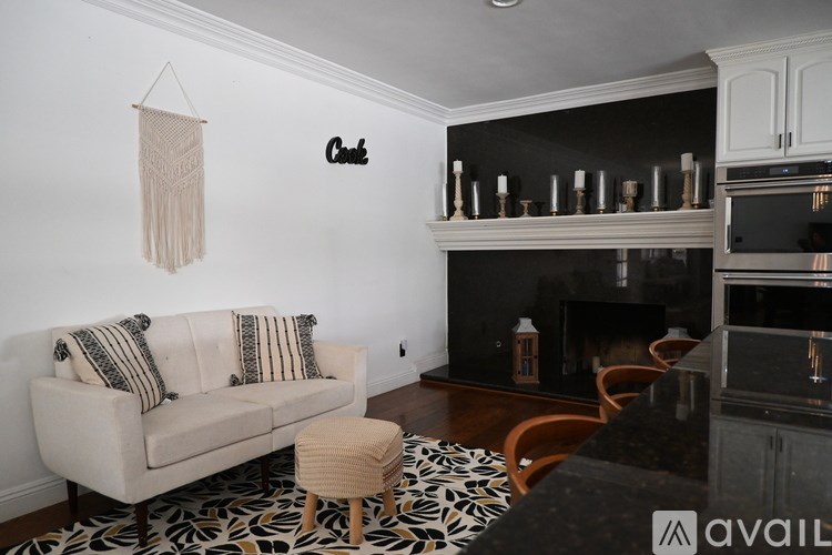 A living room with a striped couch and a ceiling fan.