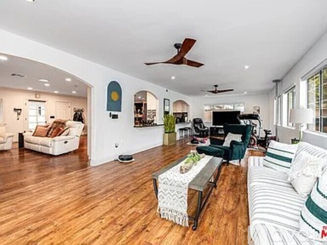 A living room with a white couch and a coffee table.