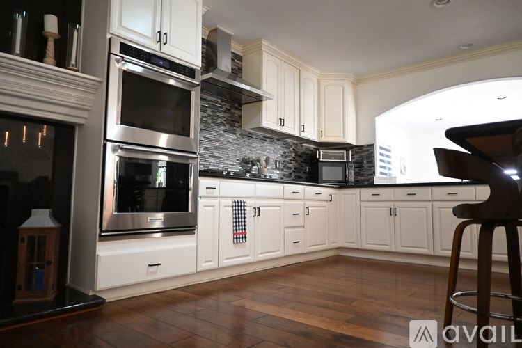 A bedroom with a large bed and a sliding glass door leading to a balcony.