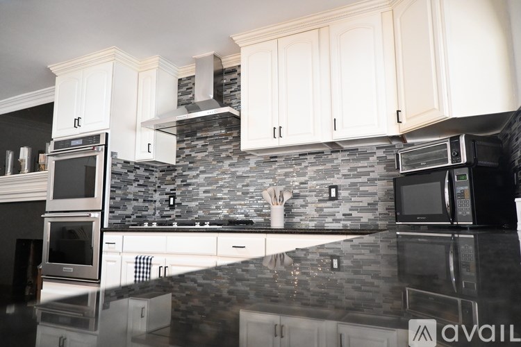 Clothes hanging on a rack in a closet.