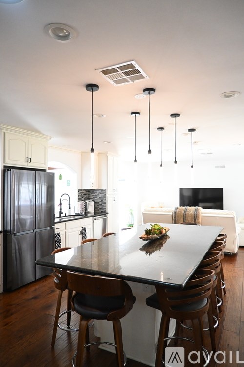 A modern kitchen with a bar area and a fireplace.