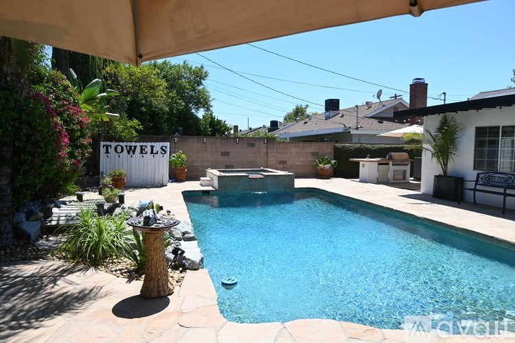 A pool with a sign that says "Towels" in the background.