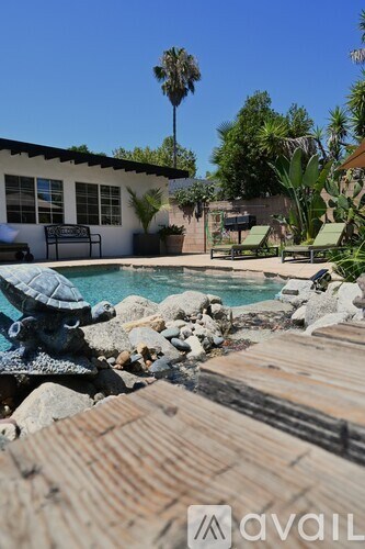 A pool with a turtle statue in the middle of it.