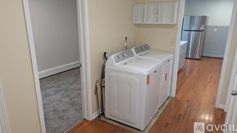A small white dishwasher and washing machine in a kitchen.