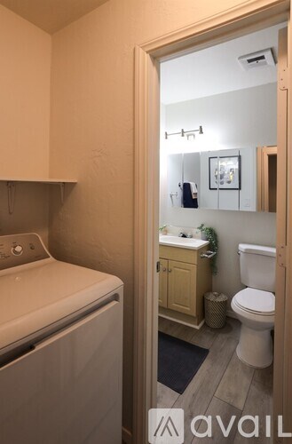 A bathroom with a washer and dryer in it.