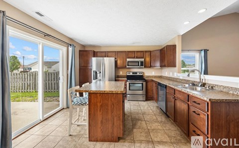 A kitchen with wooden cabinets and a granite countertop.