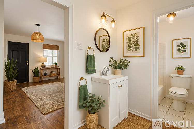 A bathroom with a toilet, sink, and potted plants.
