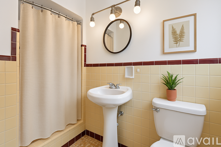 A bathroom with a sink, toilet, and shower curtain.