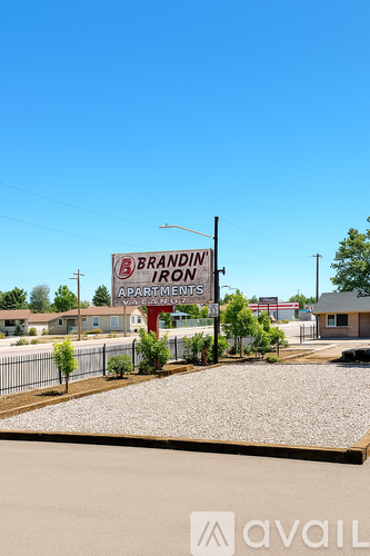 A sign for Brandin Apartments stands in front of a building.
