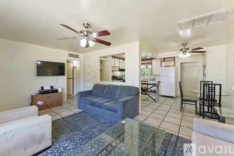 A living room with a blue couch and a television.