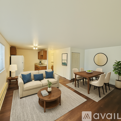 A living room with a white couch, a wooden coffee table, and a round mirror on the wall.