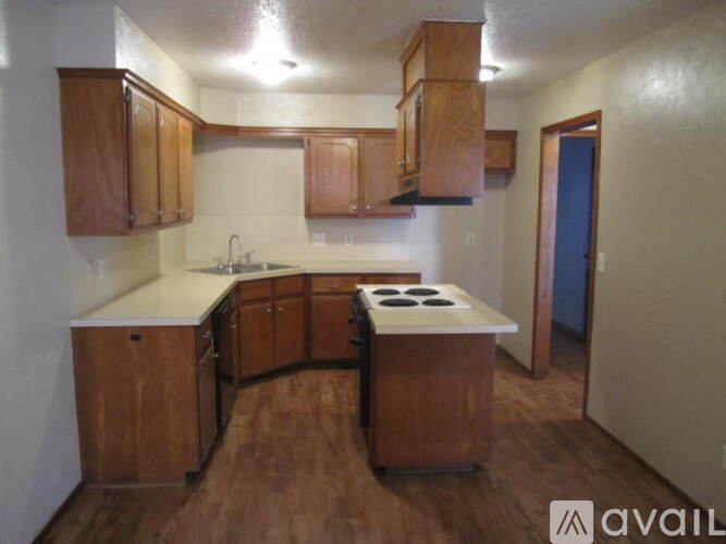 A kitchen with wooden cabinets and a white countertop.