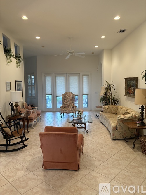 A living room with a rocking chair, a couch, and a coffee table.