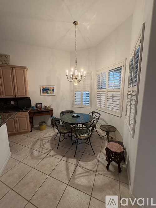 A dining room with a table and chairs.
