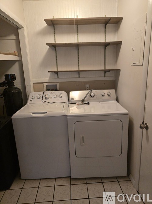 A small laundry room with a washer and dryer.