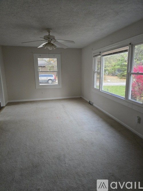 A room with a car parked outside the window.