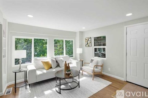 A living room with a white couch and a coffee table.
