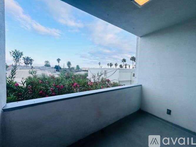 A balcony with a view of a landscape with trees and houses.