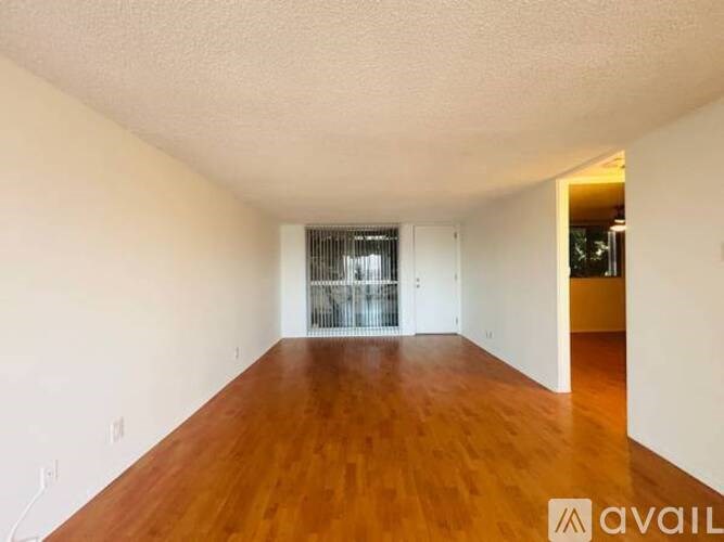 Empty room with wooden floor and white walls.