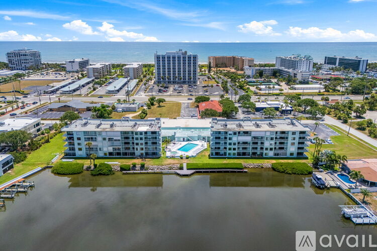 A large building with a pool in the middle of a lake.