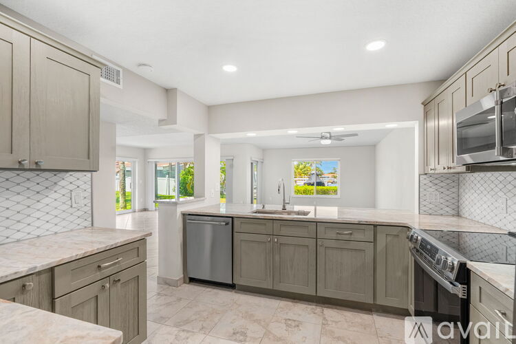A kitchen with a dishwasher and a stove top oven.