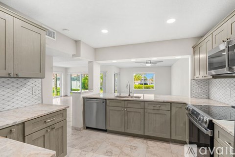 A kitchen with a dishwasher and a stove top oven.