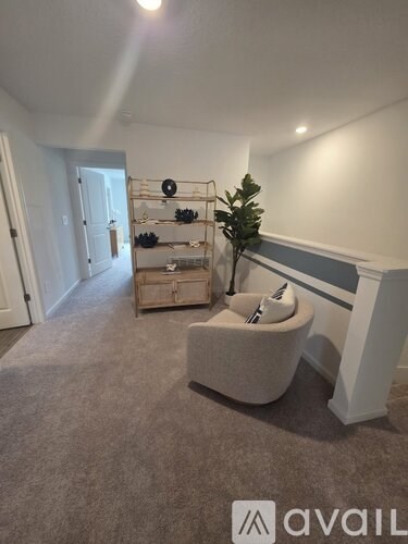 A living room with a grey sofa and a wooden cabinet.