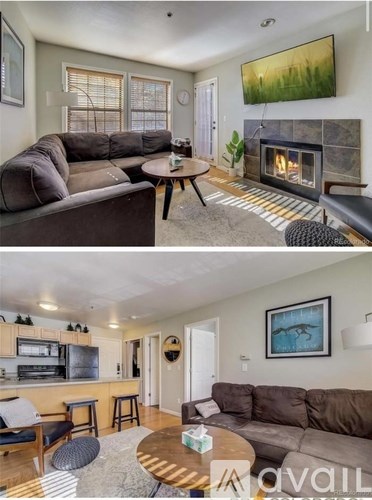 A living room with a fireplace and a painting on the wall.