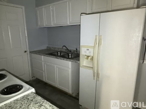 A kitchen with a white refrigerator and a white stove top oven.
