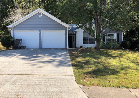 A two-car garage with a white door and a black door.